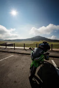 Adventure motorcycle parked on scenic Japanese mountain road with beautiful landscape views