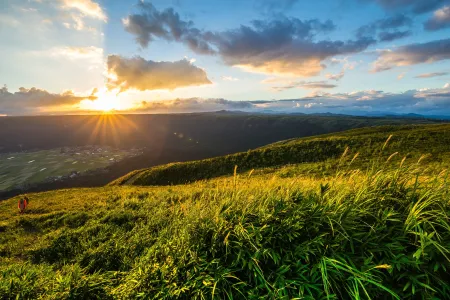 Peaceful Japanese countryside with rolling hills, fields, and traditional rural scenery