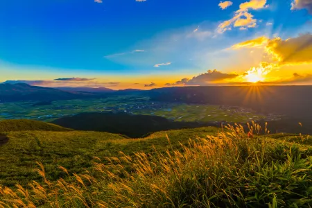 Breathtaking sunrise over mountain peaks with dramatic cloud formations and golden light