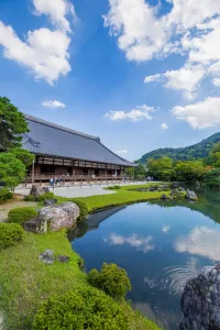 Peaceful temple garden with still water creating perfect reflections of traditional architecture
